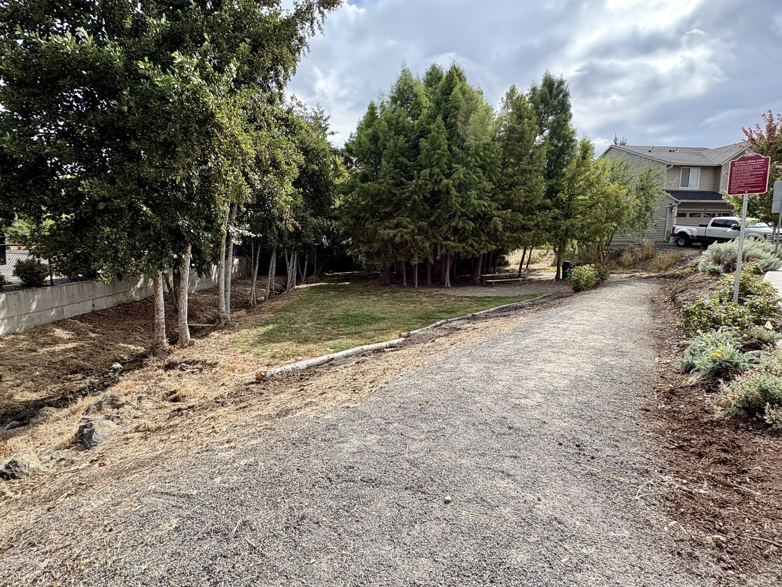 The new gravel path and park sign at Hawn Creek Pocket Park